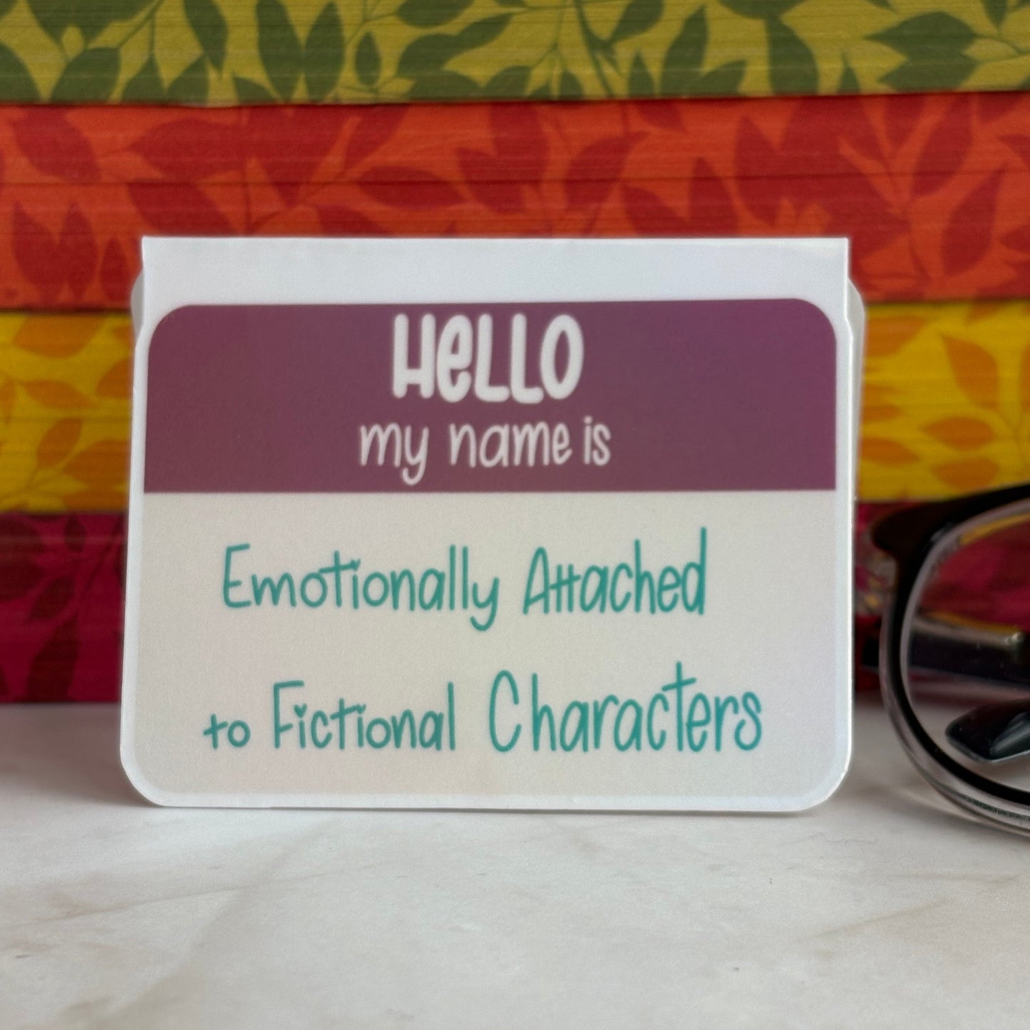 Name tag style magnetic bookmark reading, “Hello my name is Emotionally Attached to Fictional Characters”.