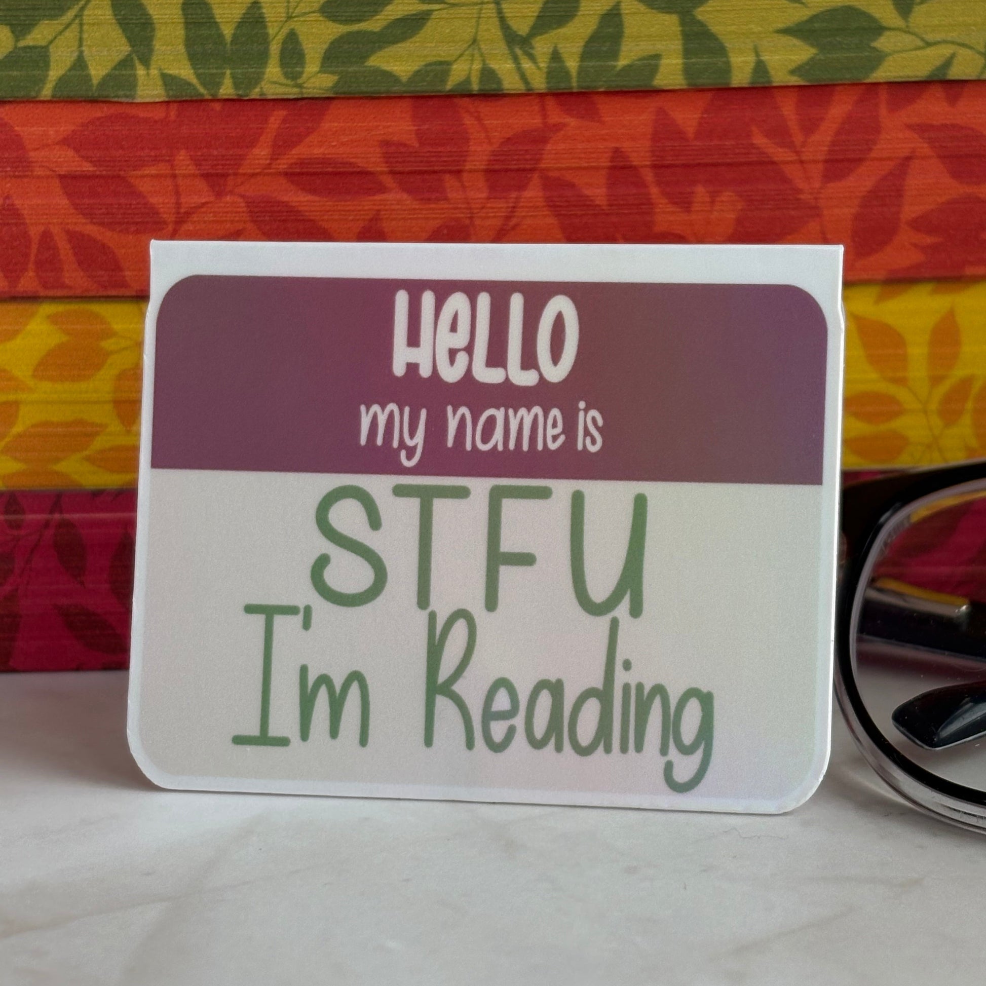 Name tag style bookmark with text 'Hello my name is STFU I'm Reading' on a colorful background