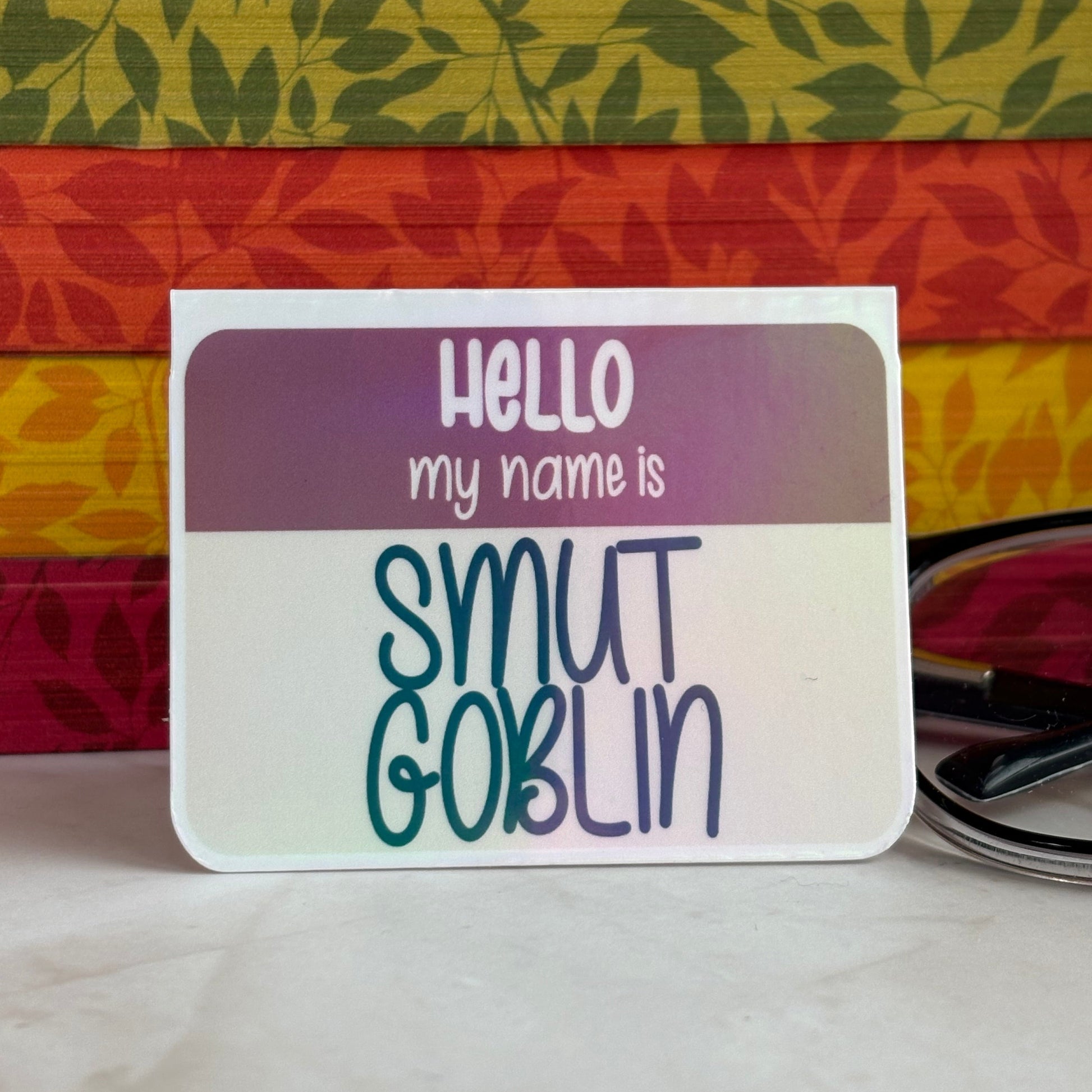 A name tag style magnetic bookmark reading 'Hello my name is Smut Goblin'.
